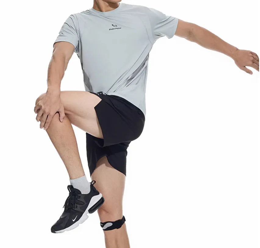 Men's black running shorts with laser stitching on a grey background, showing stretch fabric.