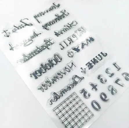 Close-up of a transparent silicone craft stamp featuring vintage-style calendar icons on a digital table background.