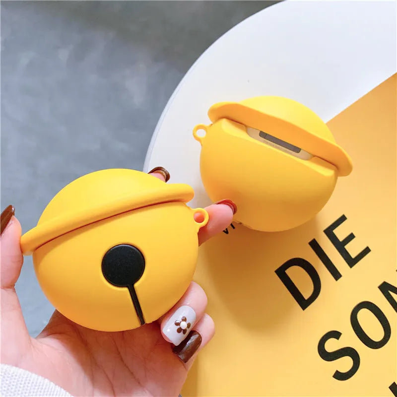 Yellow silicone AirPods case with decorative bell charm for wireless earbuds protection
