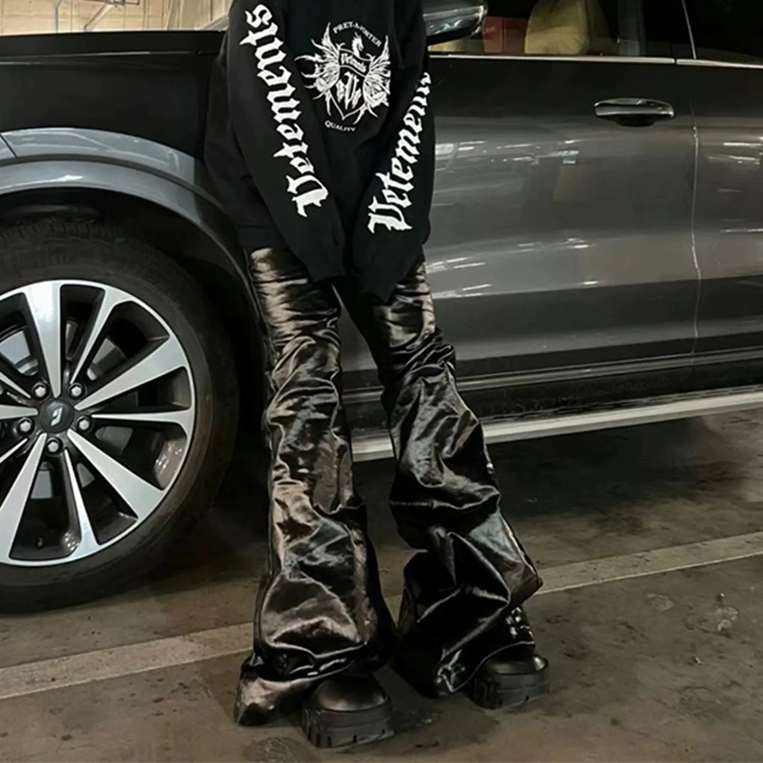 Black straight-leg jeans with patent leather coating on cotton denim fabric