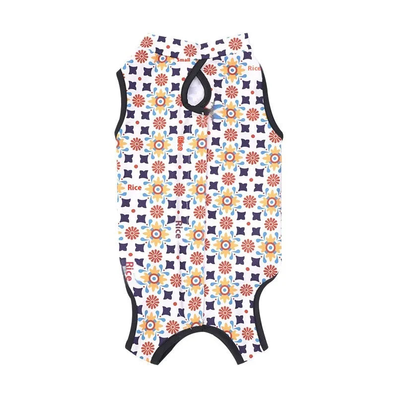 Cat wearing a patterned post-surgery recovery suit with Velcro fastenings on the back.