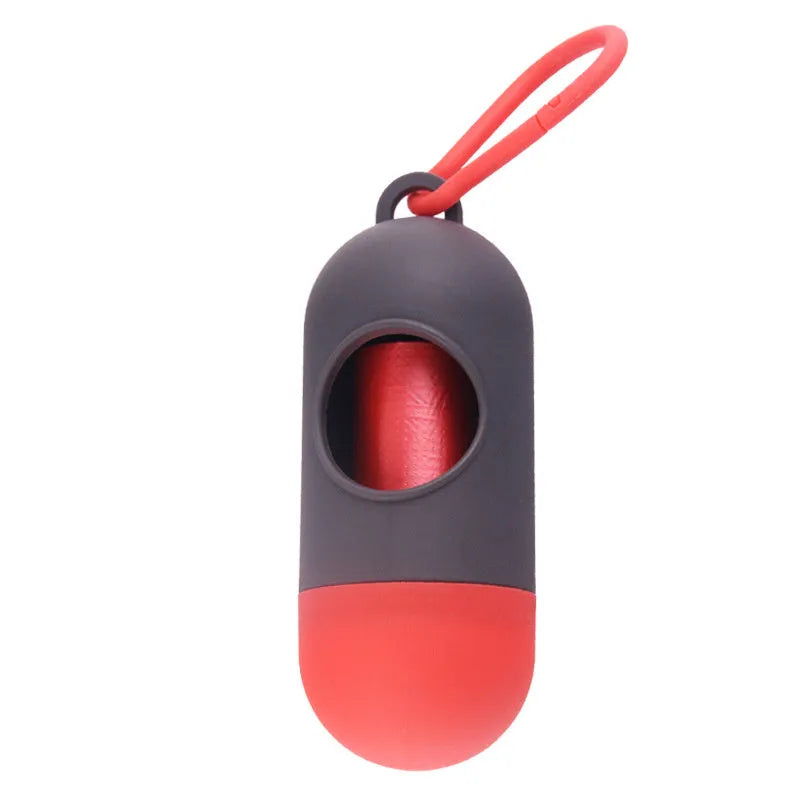 Black plastic dog poop bag holder with a metal side hook and Velcro strap, showing compact size.
