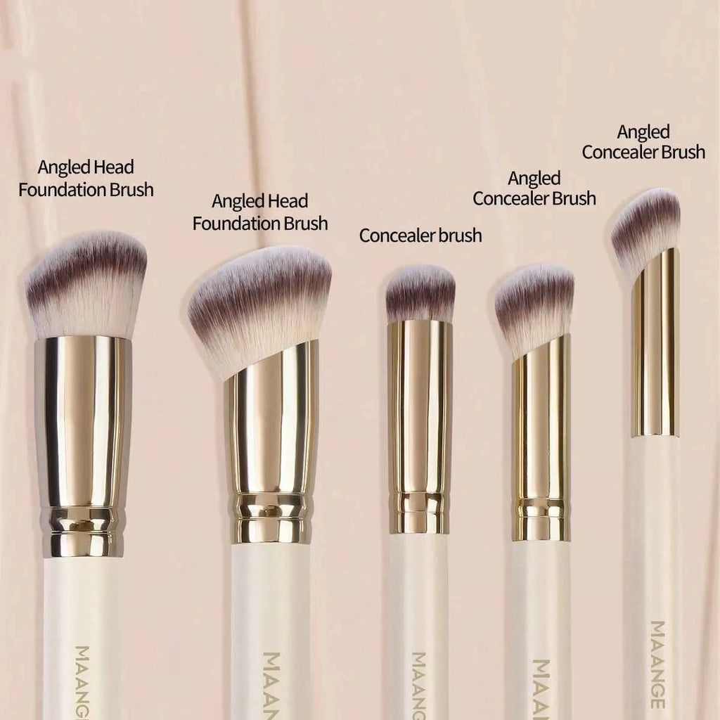 Angled apricot blusher brush and four other synthetic makeup brushes on a white surface.