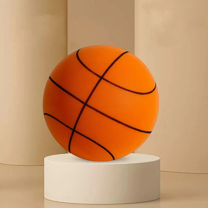 Assortment of bright coloured silent foam basketballs with a basketball frame on a neutral background