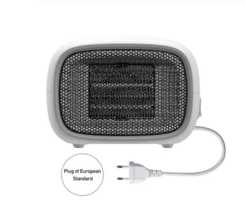 Compact green mini ceramic heater with metal mesh front on a wooden desk