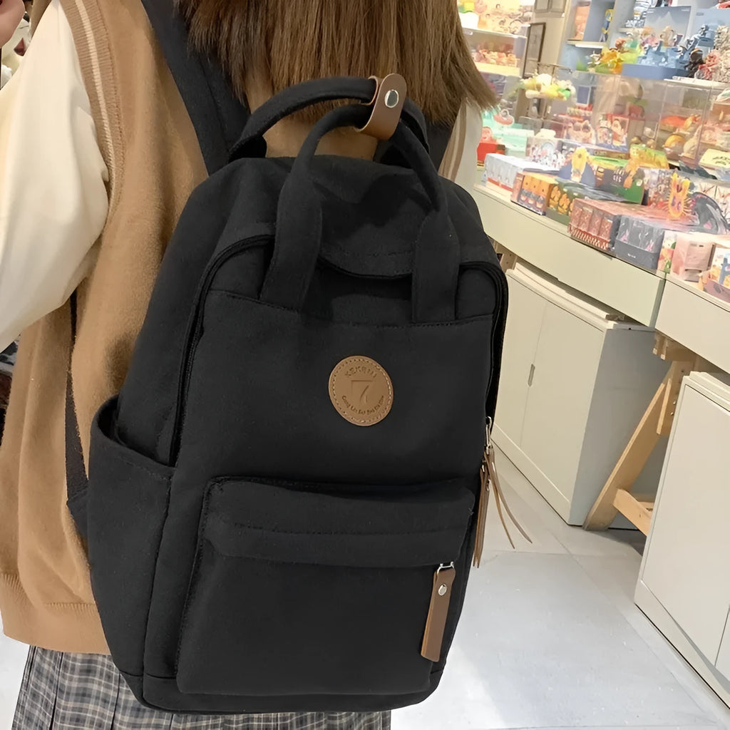 Black Oxford cloth backpack with curved shoulder straps in urban simplicity style