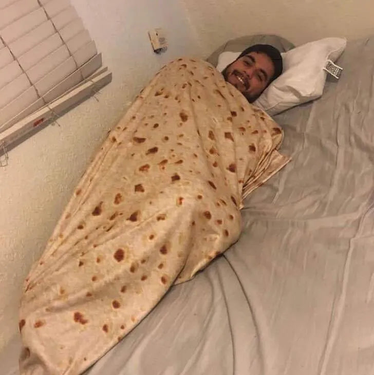 Round burrito design blanket in coral fleece flannel with tortilla print, folded to show size