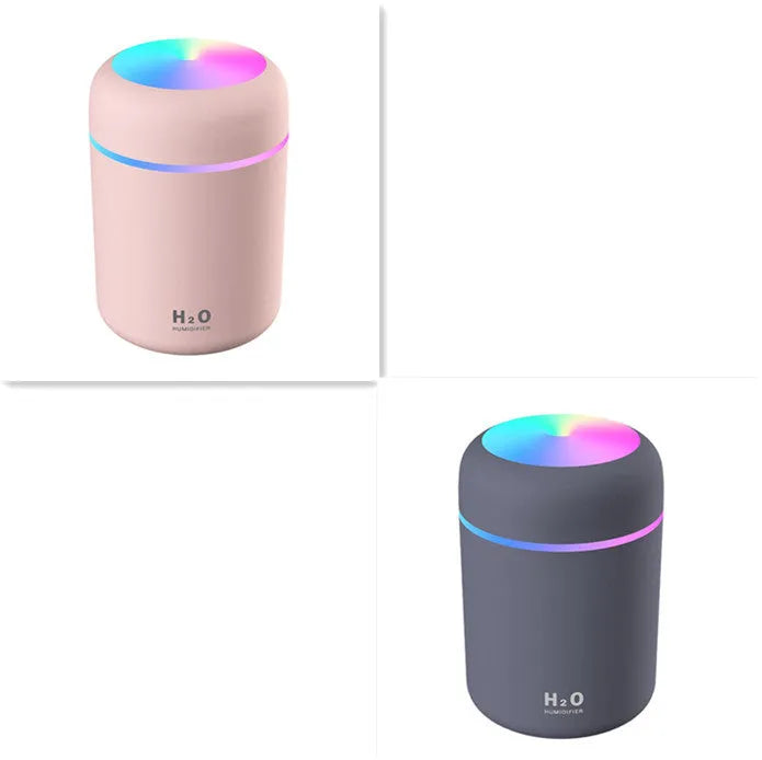 Pink USB desktop humidifier with colourful LED lights and 300ml water tank on wooden desk