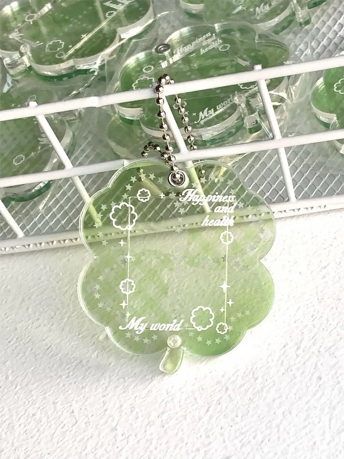 Acrylic four-leaf clover keychain pendant in blue, green, or mint colour options.