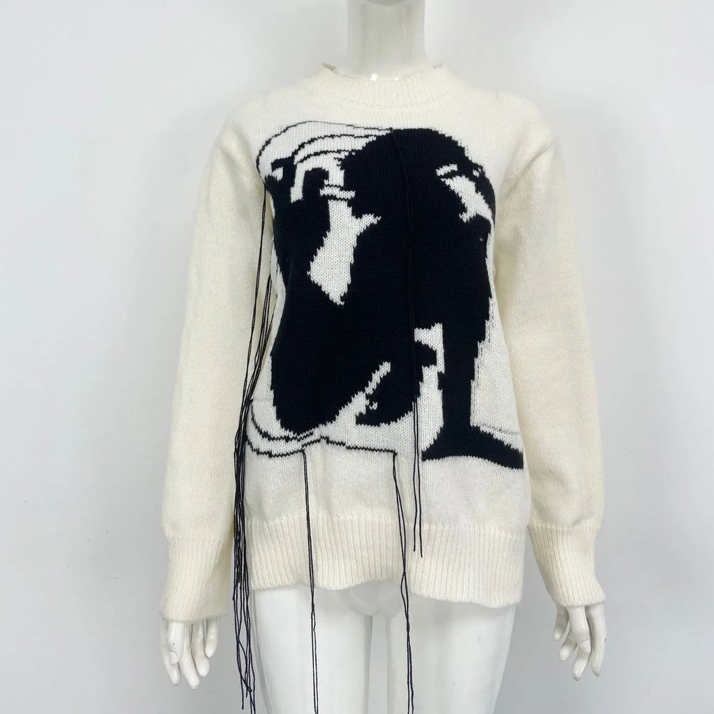 Women's grey alpaca wool sweater with tassel detailing and round neck.