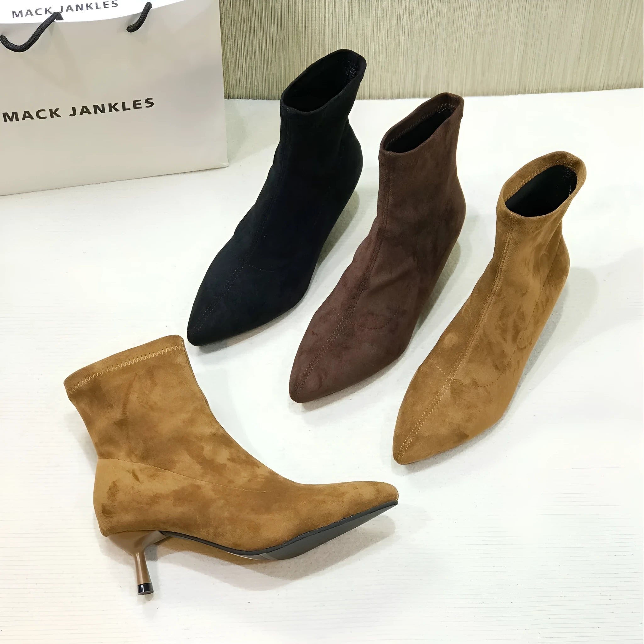 Black pointed toe women's ankle boots with stiletto heel and mid-calf height