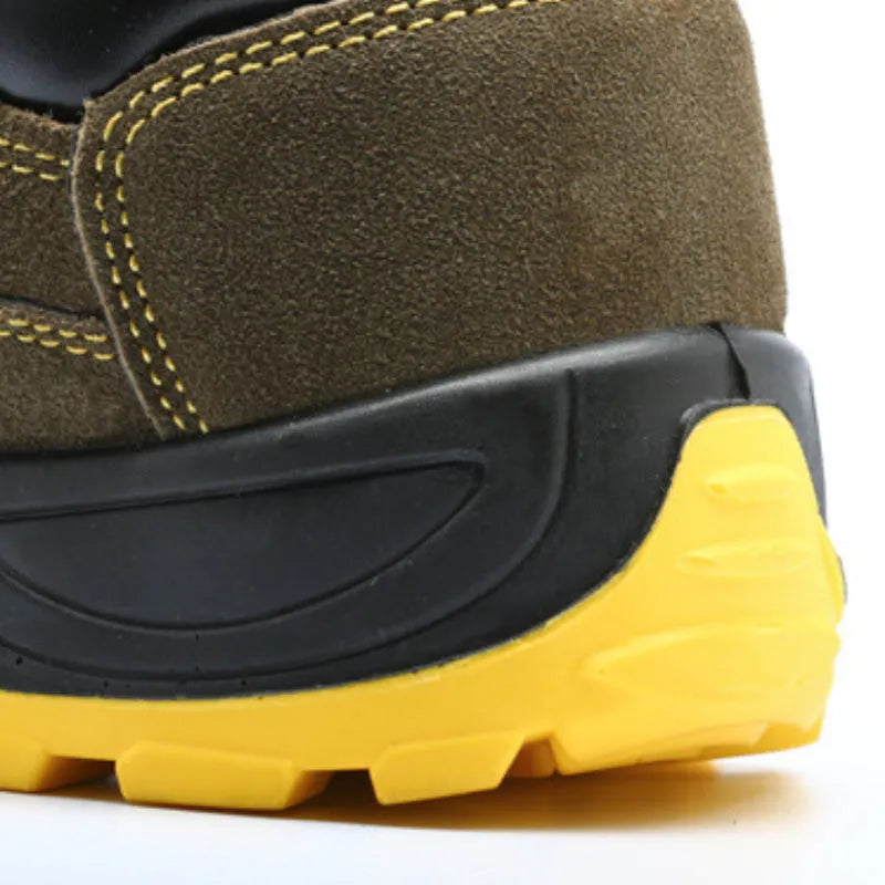 Bronze coloured leather safety boots with steel toe cap on a work site background