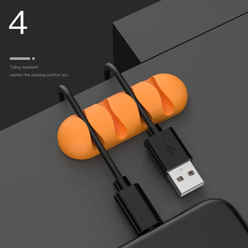 Smart cable holder with TPR flexible clips in black holding USB earphone and network cables on a desk