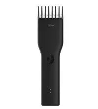 Black cordless electric hair clipper with adjustable length comb and ceramic cutter head on a white background