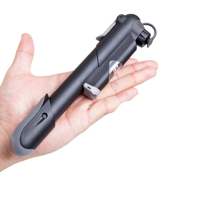 Black bicycle mini pump with round handle, 18cm length, 106g weight, on a wooden surface with bracket and mounting tape