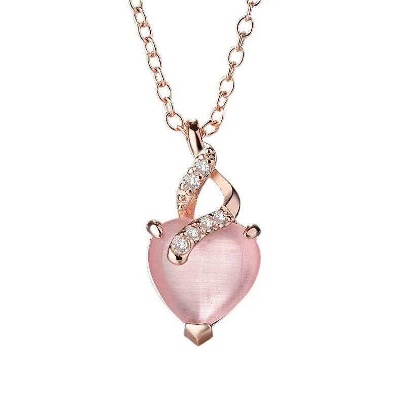 Women's heart-shaped pink crystal pendant with rose gold electroplated finish and matching cross chain