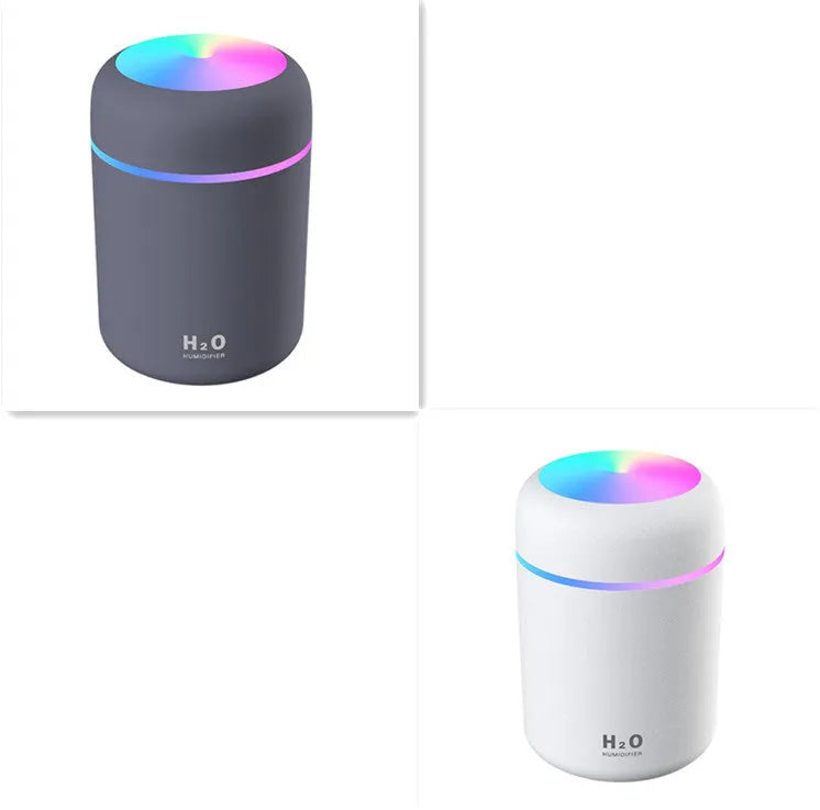 Pink USB desktop humidifier with colourful LED lights and 300ml water tank on wooden desk