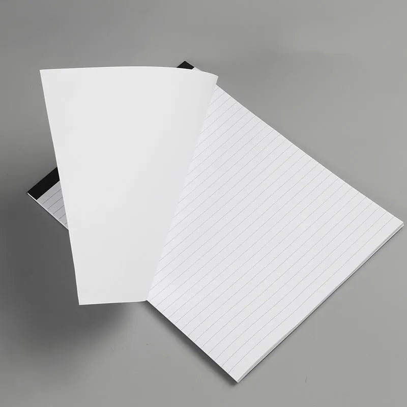 A4 tearable notebook with grid-lined ivory paper and a paper cover, showing wireless adhesive binding
