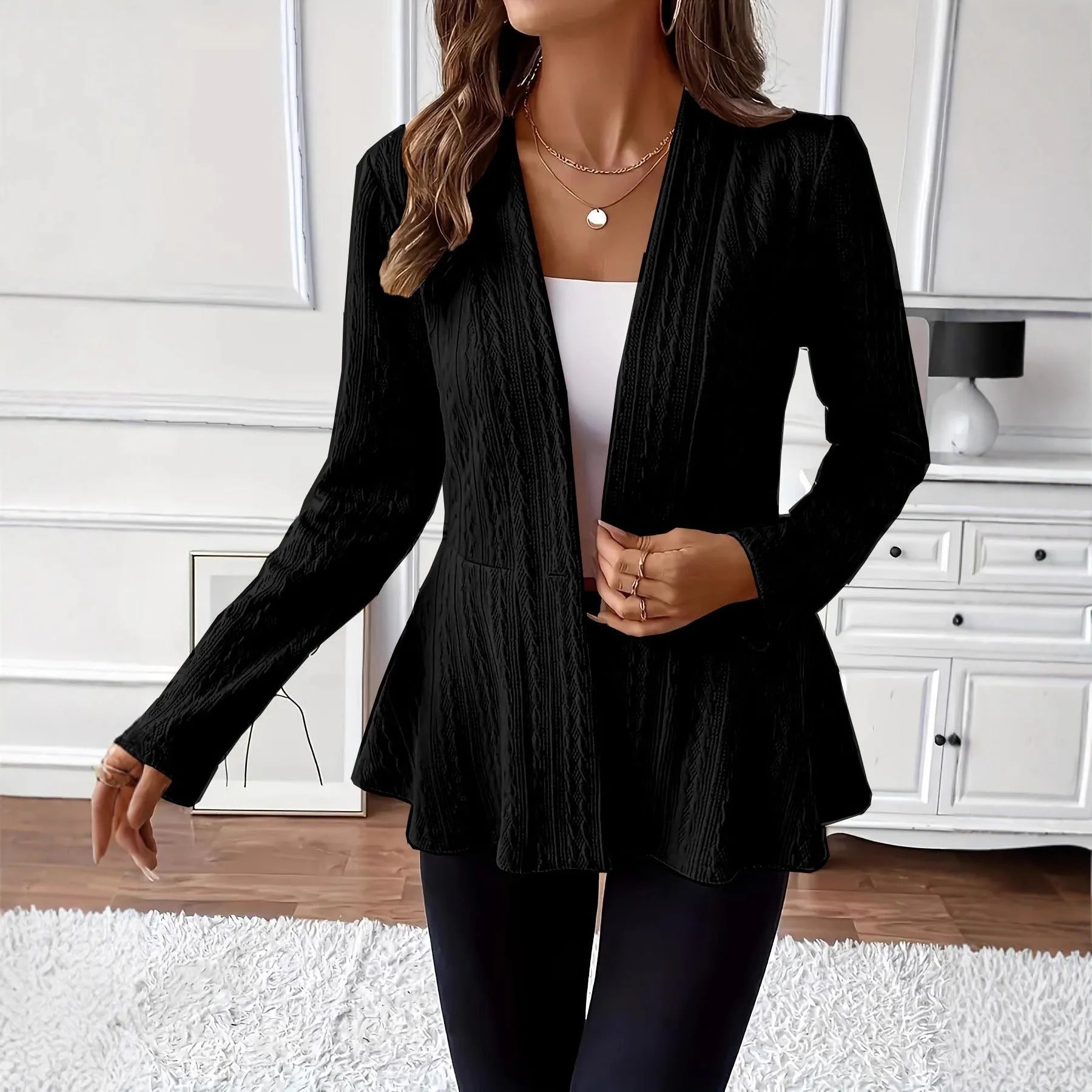 Women's apricot Jacquard knitted cardigan with a single button and long sleeves, laid flat.