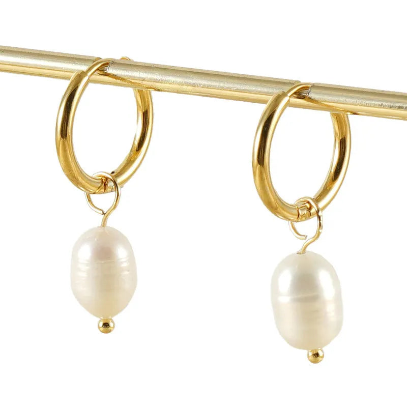 Pair of gold geometric earrings with pearl detail on titanium steel posts