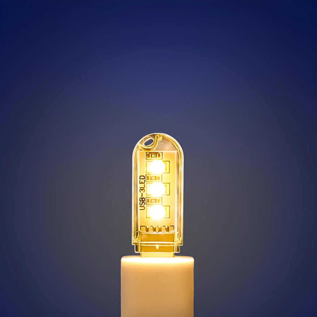 Small white cylindrical USB LED night light showing white and warm light colour options.