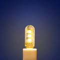 Small white cylindrical USB LED night light showing white and warm light colour options.