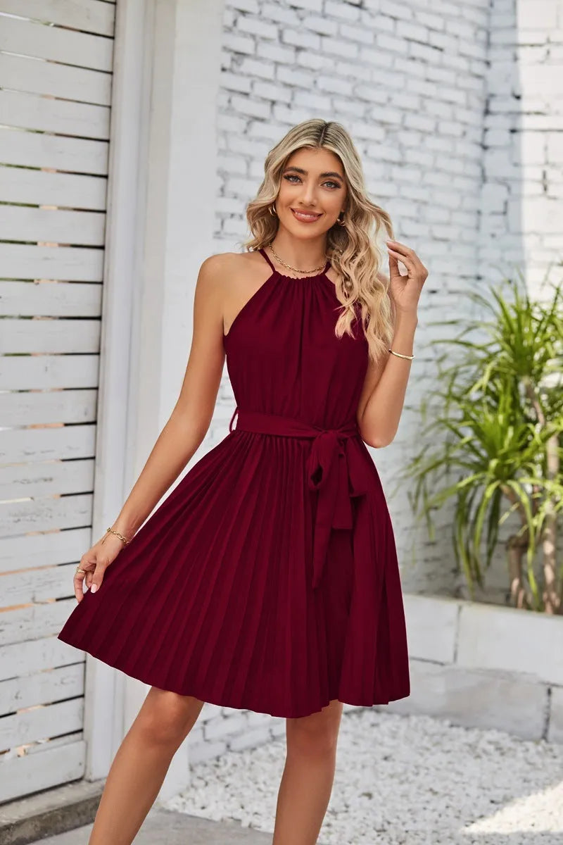 Women's black halter neck strapless sundress with a pleated midi skirt and an adjustable waist belt.