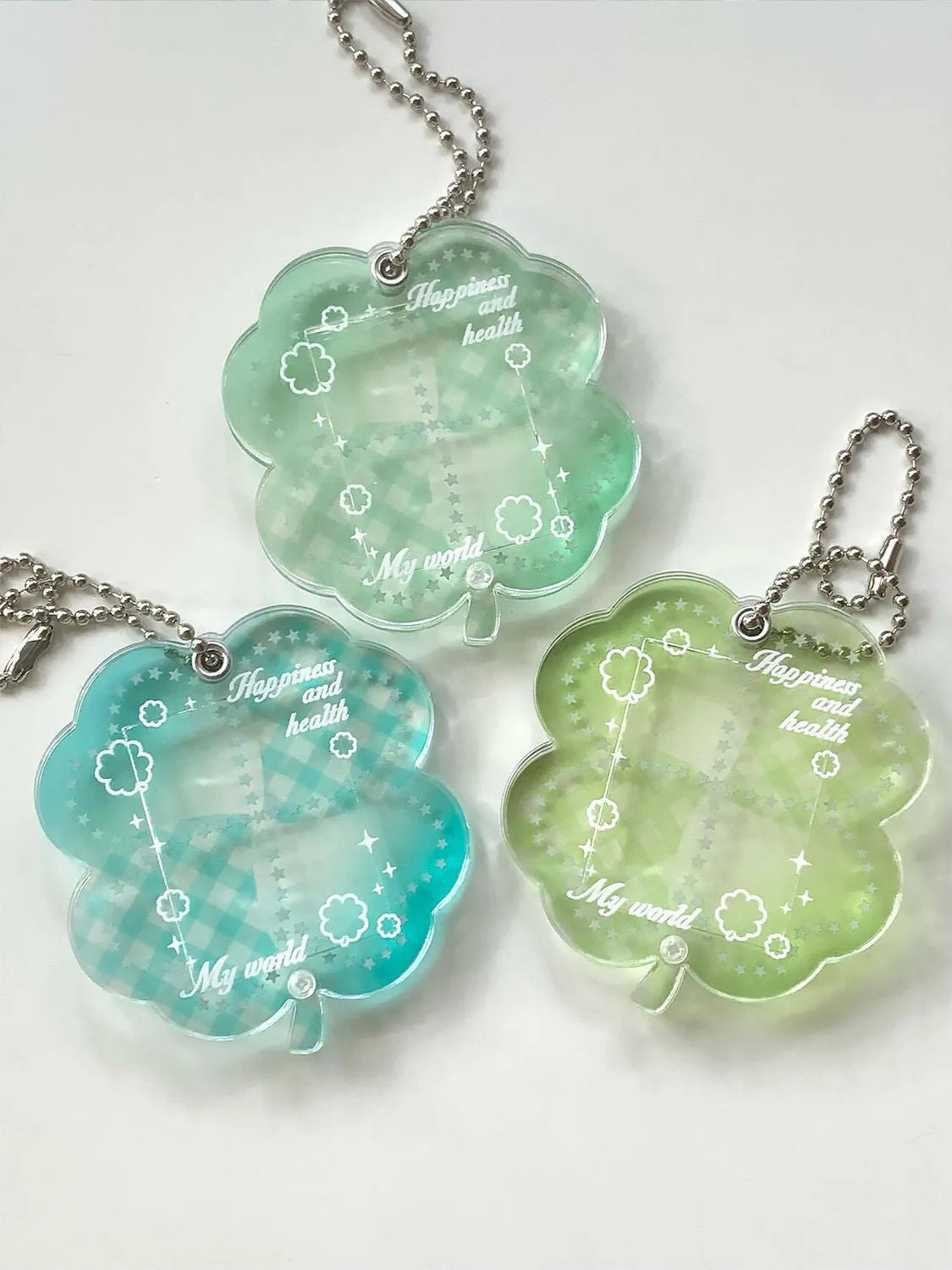 Acrylic four-leaf clover keychain pendant in blue, green, or mint colour options.