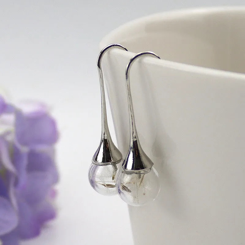 Transparent glass earrings with crystal dandelion seed design on French hooks