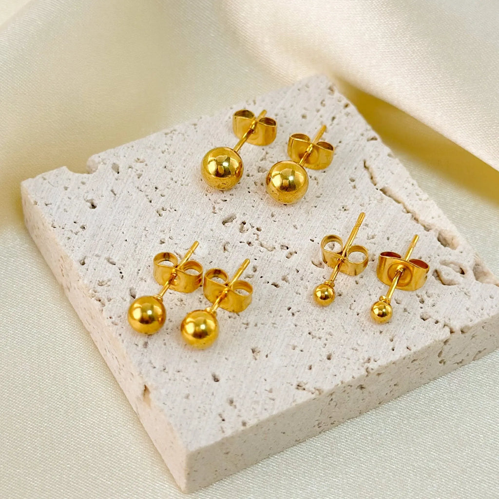 Titanium steel ball stud earrings in gold or silver finish, available in 3mm to 6mm sizes