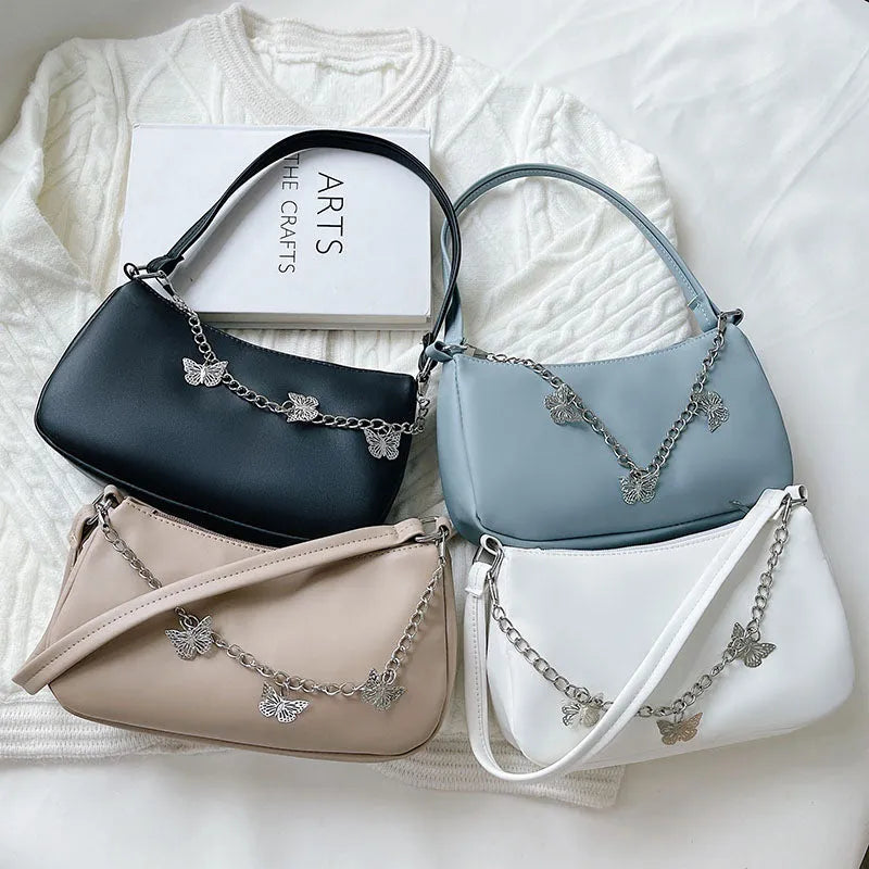Retro women's chain-strap crossbody bag with butterfly charm in light blue PU leather