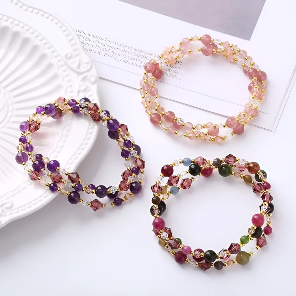 Women's adjustable bracelet with tourmaline, strawberry quartz, or amethyst crystal beads on a cord.