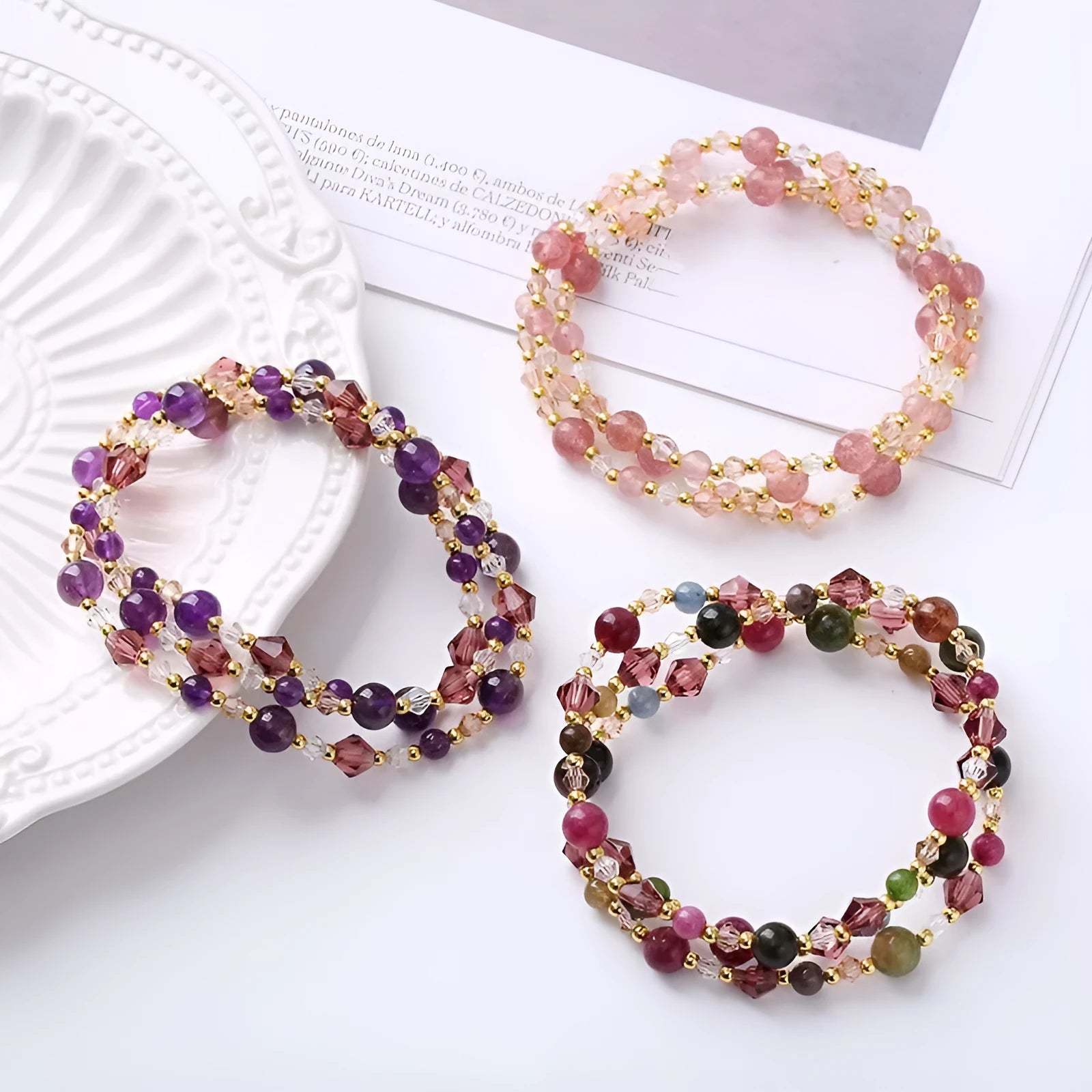 Women's adjustable bracelet with tourmaline, strawberry quartz, or amethyst crystal beads on a cord.