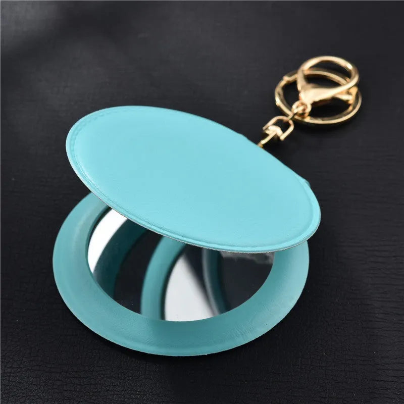 Compact round ladies leather makeup mirror with 8cm diameter glass surface and golden buckle
