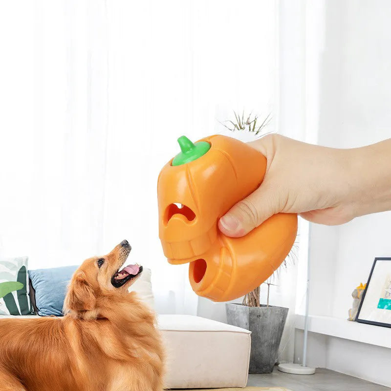 Orange Halloween pumpkin shaped dog chew toy with a treat-dispensing funnel hole