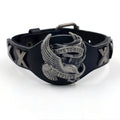 Black leather bracelet with an alloy eagle decoration and watch-button clasp on a wrist.