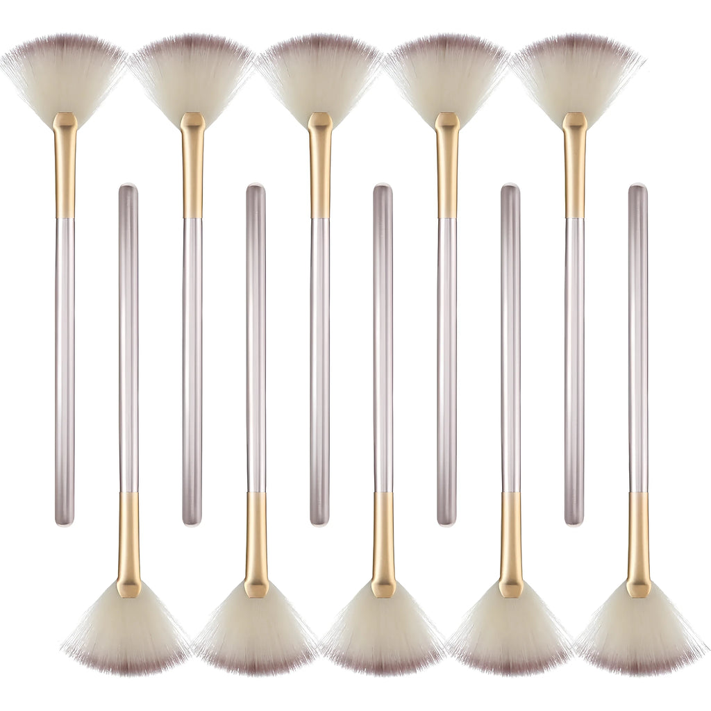 Ten champagne-coloured facial fan brushes with acrylic handles and protective covers.