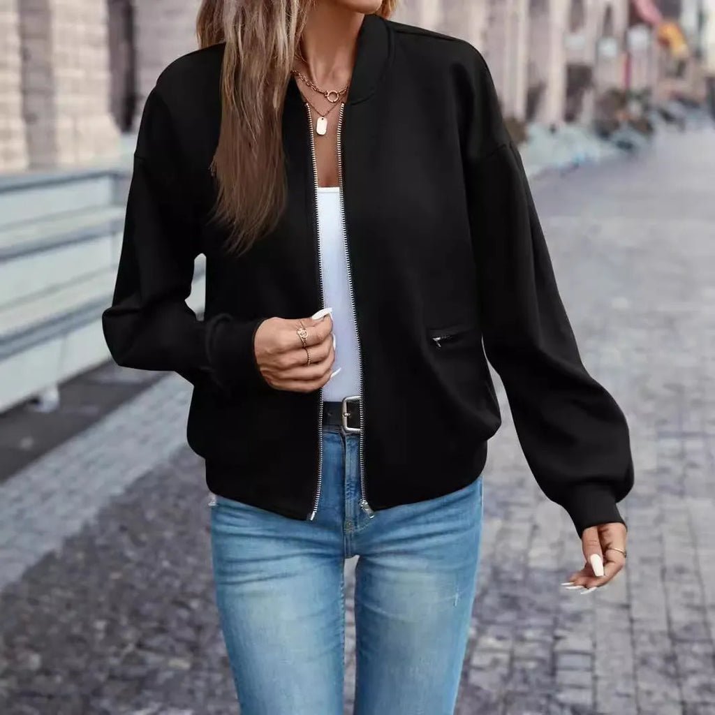 Black women's casual zip-up jacket with long sleeves and faux pockets on a hanger.