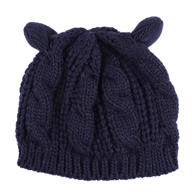 Hand made 3D knitted cat ear beanie in wool, shown in multiple colour options including red, black and beige.