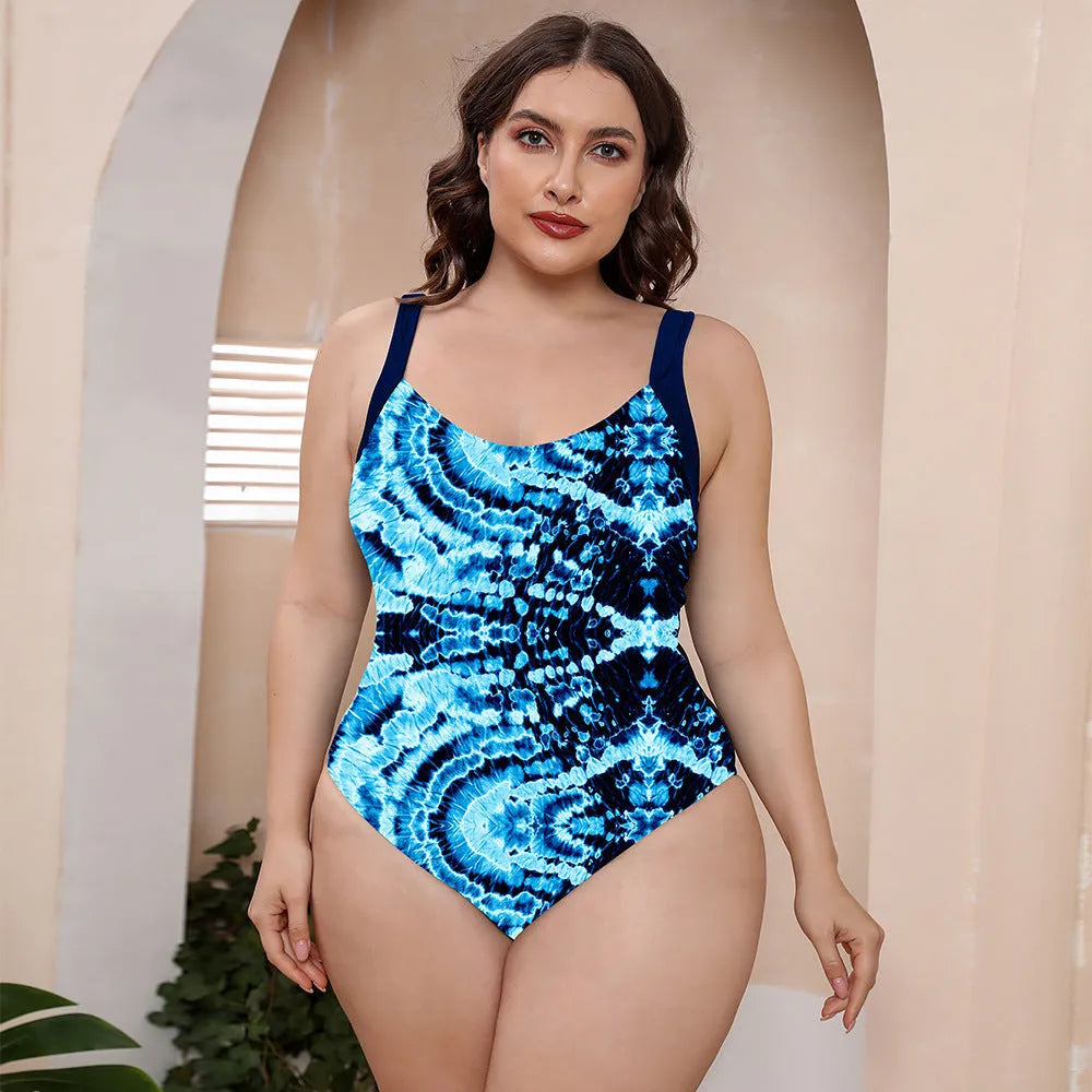 Floral print one-piece swimsuit with spaghetti straps and a conservative vest-style top.