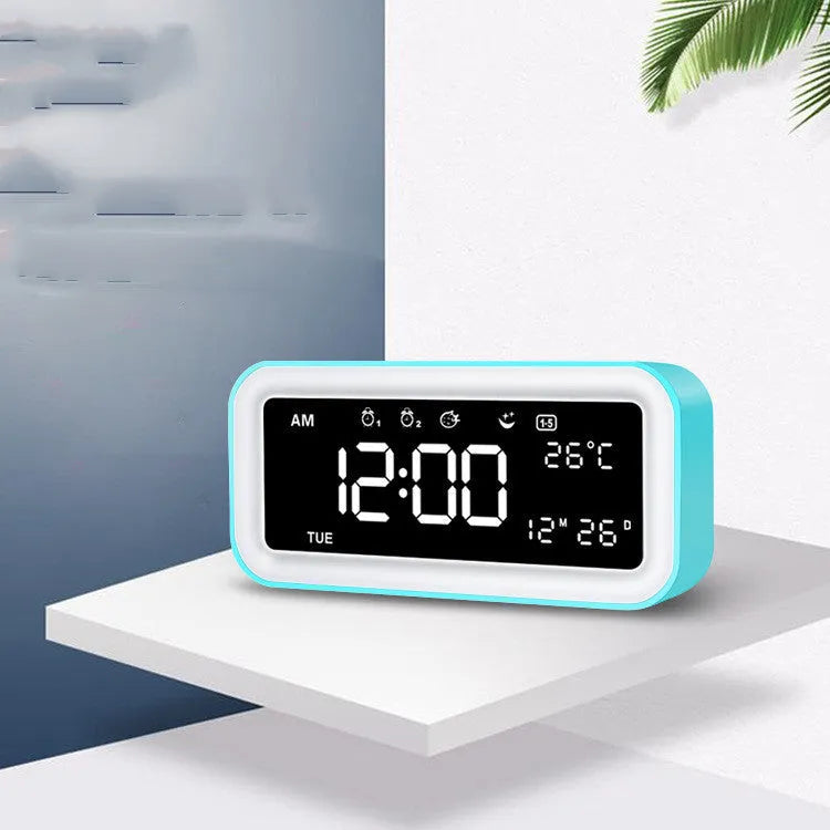 Blue rectangular LED digital alarm clock with multicolour light settings on a wooden surface.