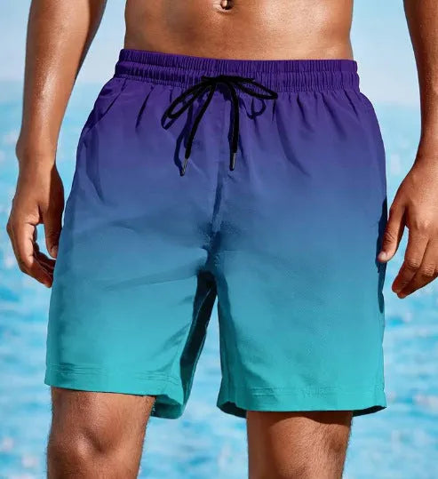 Man wearing grey gradient 3D printed mesh sports shorts against a plain background.