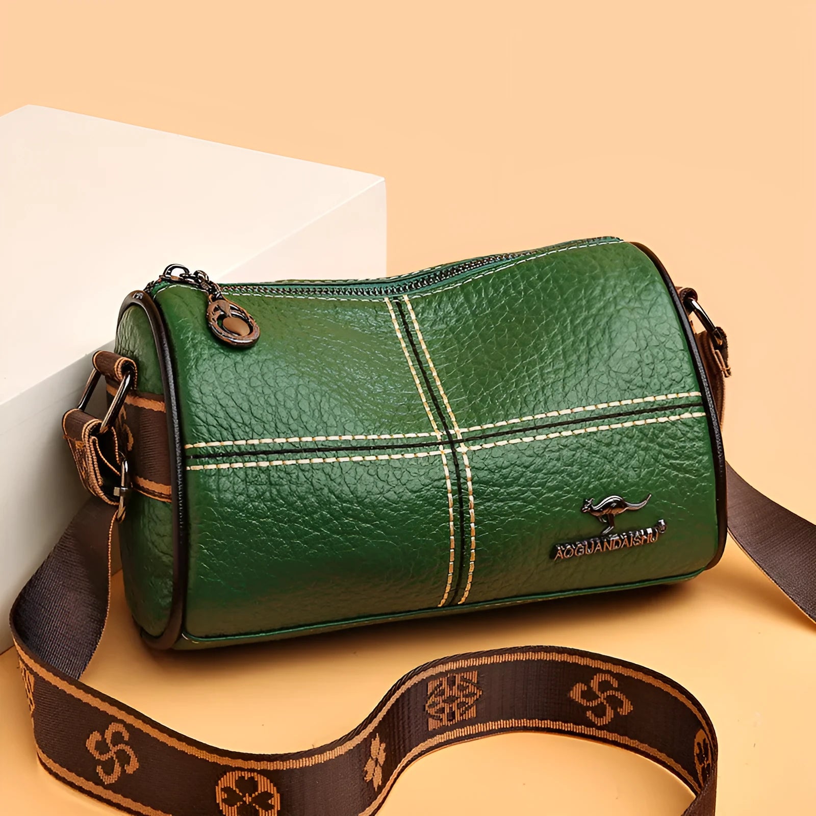 Women's casual stitched genuine leather shoulder bag in cylindrical shape, available in black, brown, green, and white