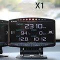 X1 Automotive OBD diagnostic instrument with LED display, metal housing, and connected power cord.