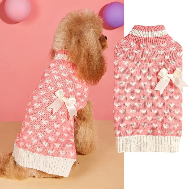 Red dog sweater with a white love heart and bow design on a small dog.
