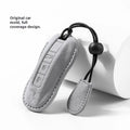 Suede car key cover in cement grey, dark green, light grey, and orange colour options.