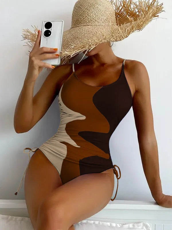 Women's blue sleeveless one-piece swimsuit with fixed trunks on a mannequin.