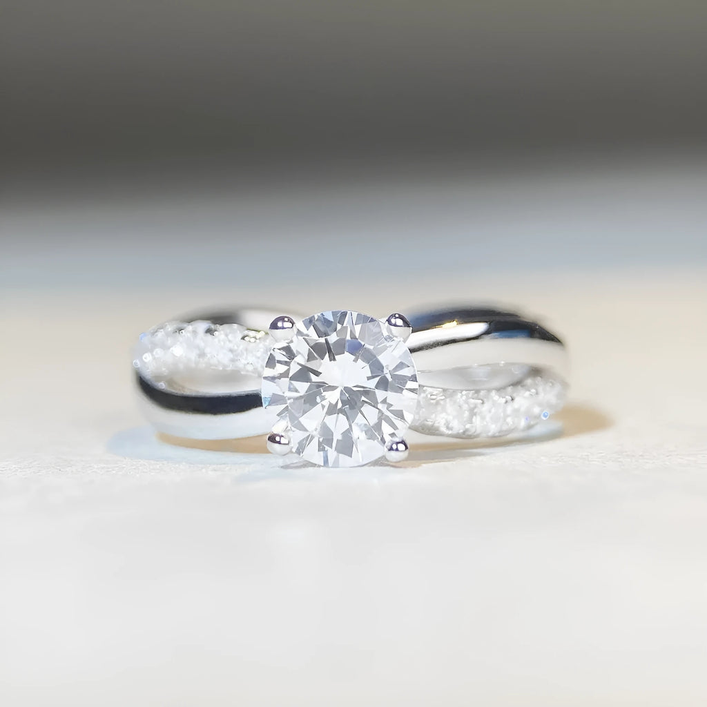 Silver geometric twist band ring with a 1-carat Moissanite stone in a four-claw setting.