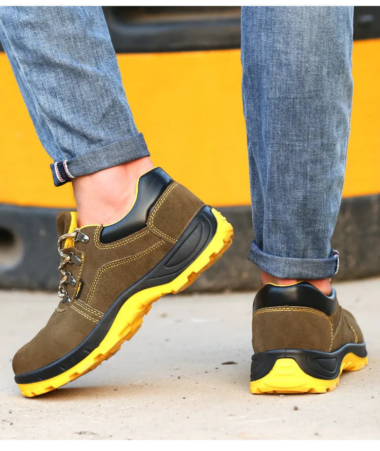 Bronze coloured leather safety boots with steel toe cap on a work site background