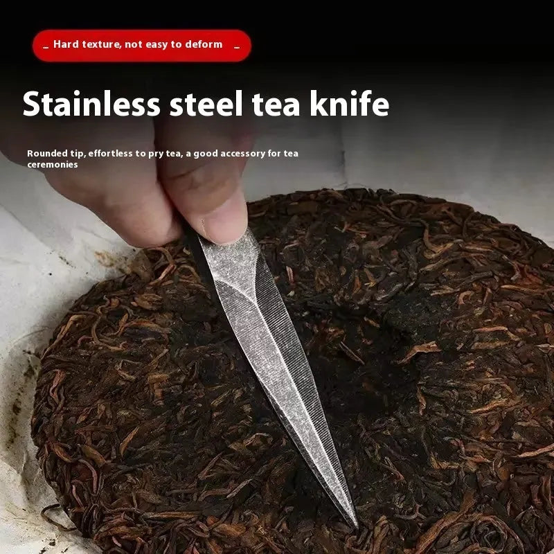 Black stainless steel hand pry tea knife with pointed blade on plain background